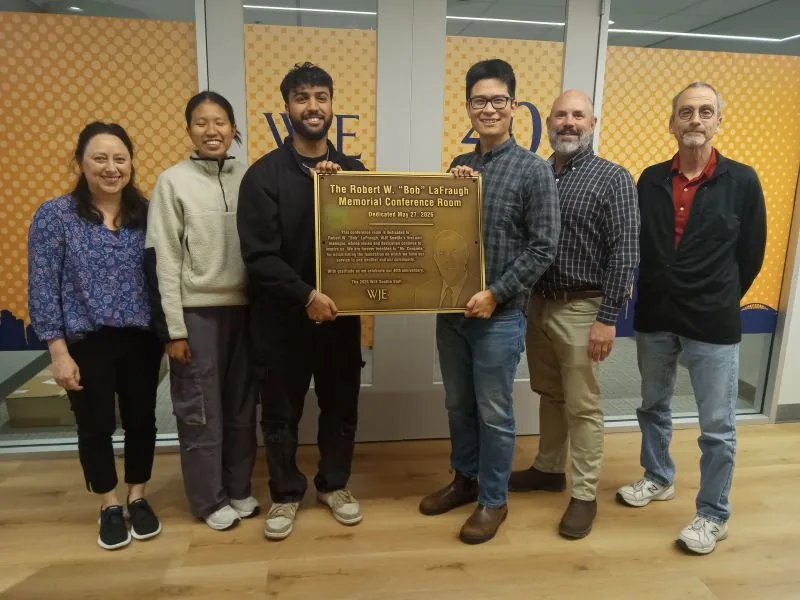 The WJE Seattle staff holding the finished bronze LaFraugh Memorial Conference Room dedication plaque at the dedication ceremony.