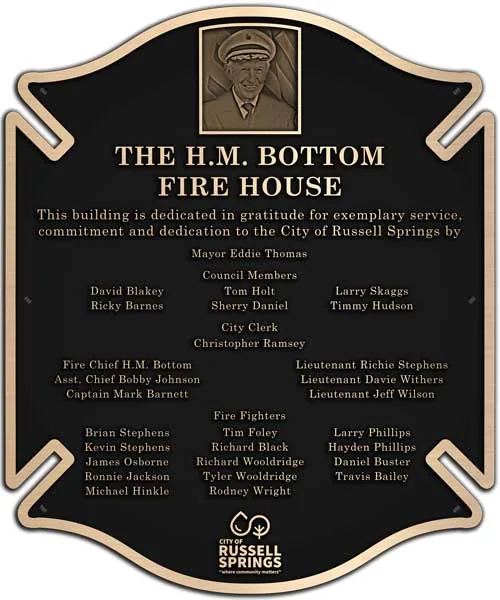 Bronze fire house plaque with a raised portrait of the chief above the department roster