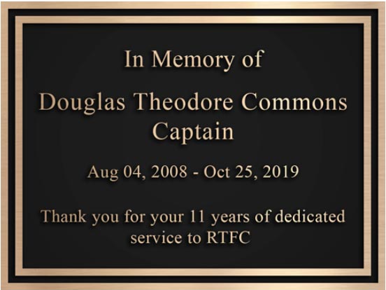 a fire truck memorial dedication plaque in honor of a fire cheif