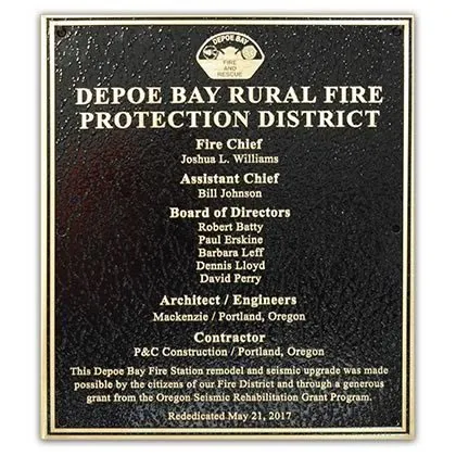 Bronze rural fire protection district plaque listing the chief, board of directors, and contractors