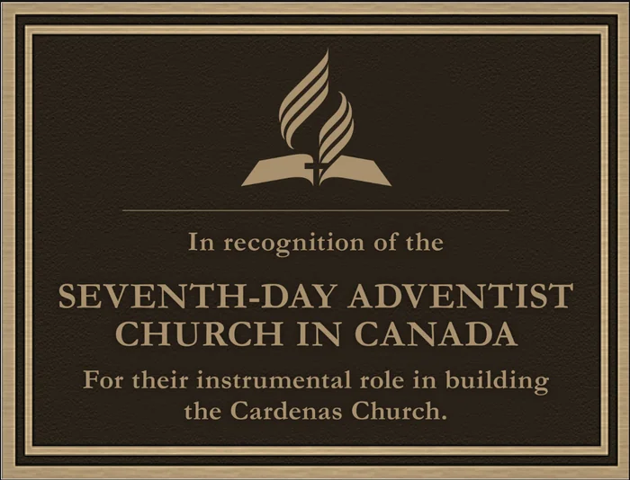 Bronze recognition plaque honoring the Seventh-Day Adventist Church in Canada with a denominational emblem.