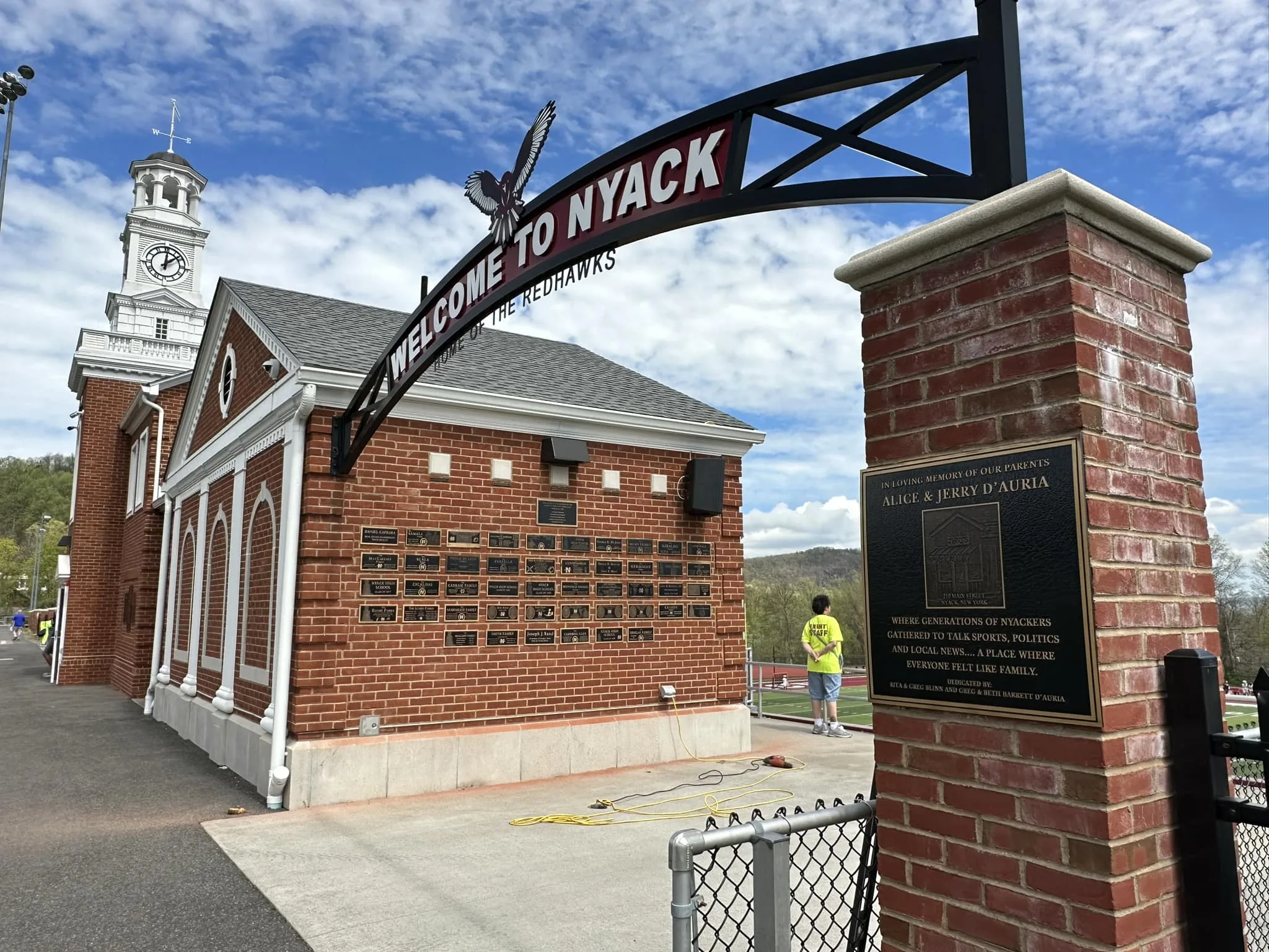 A bronze donor and sponsor wall at Nyack High School stadium, filled with custom family and sponsor plaques.