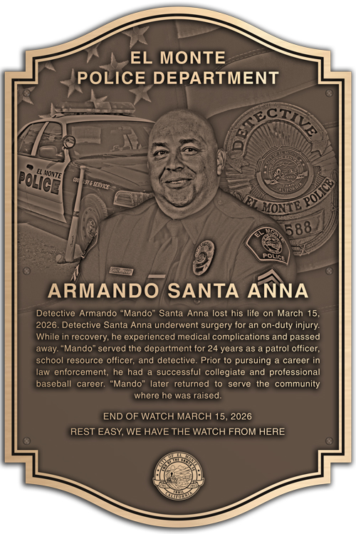 A bronze memorial plaque honoring a fallen police officer.